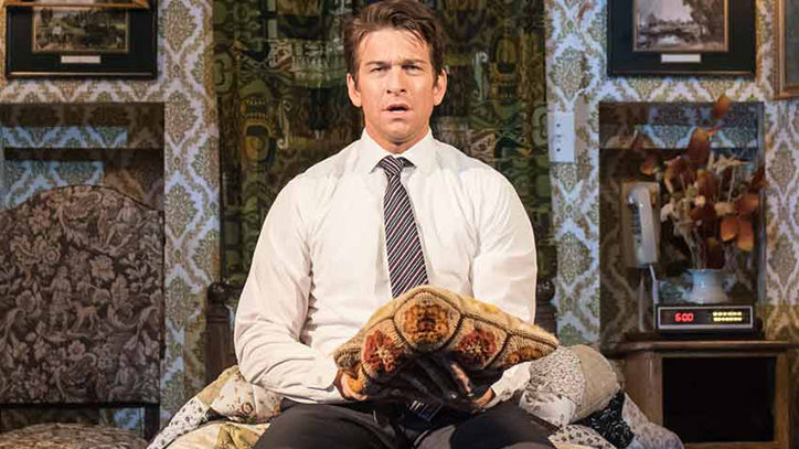Andy Karl sitting on a bed in Groundhog Day the Broadway musical